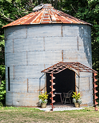 Recycled augurs frame the entrance to an old grain bin.