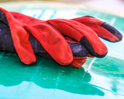 Red gloves form sculptural fingers.